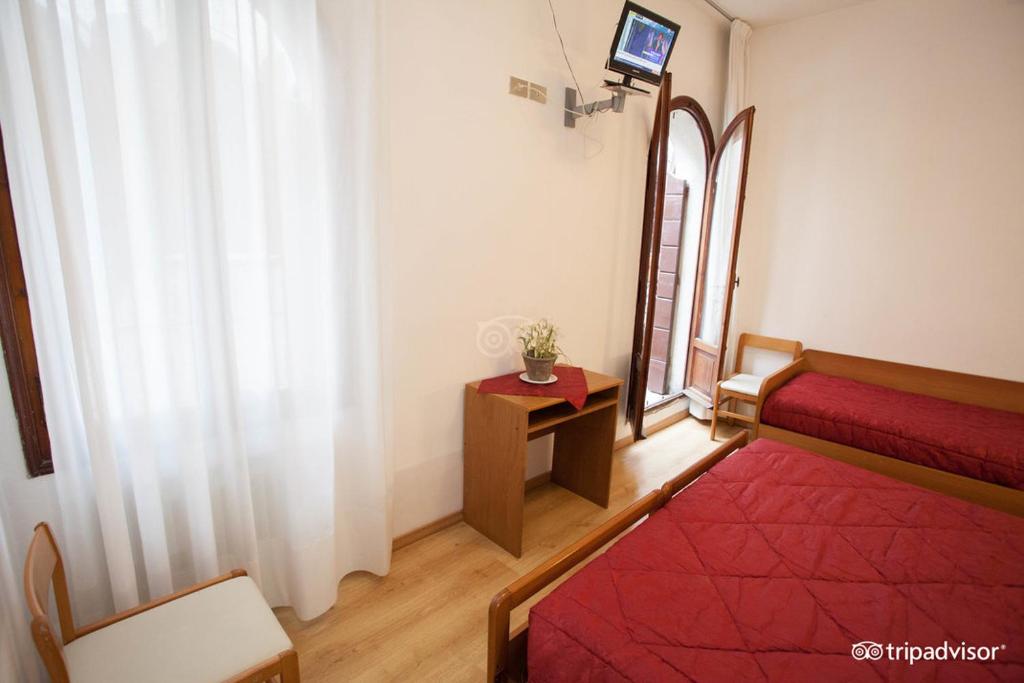 Postel nebo postele na pokoji v ubytování Hotel Caprera