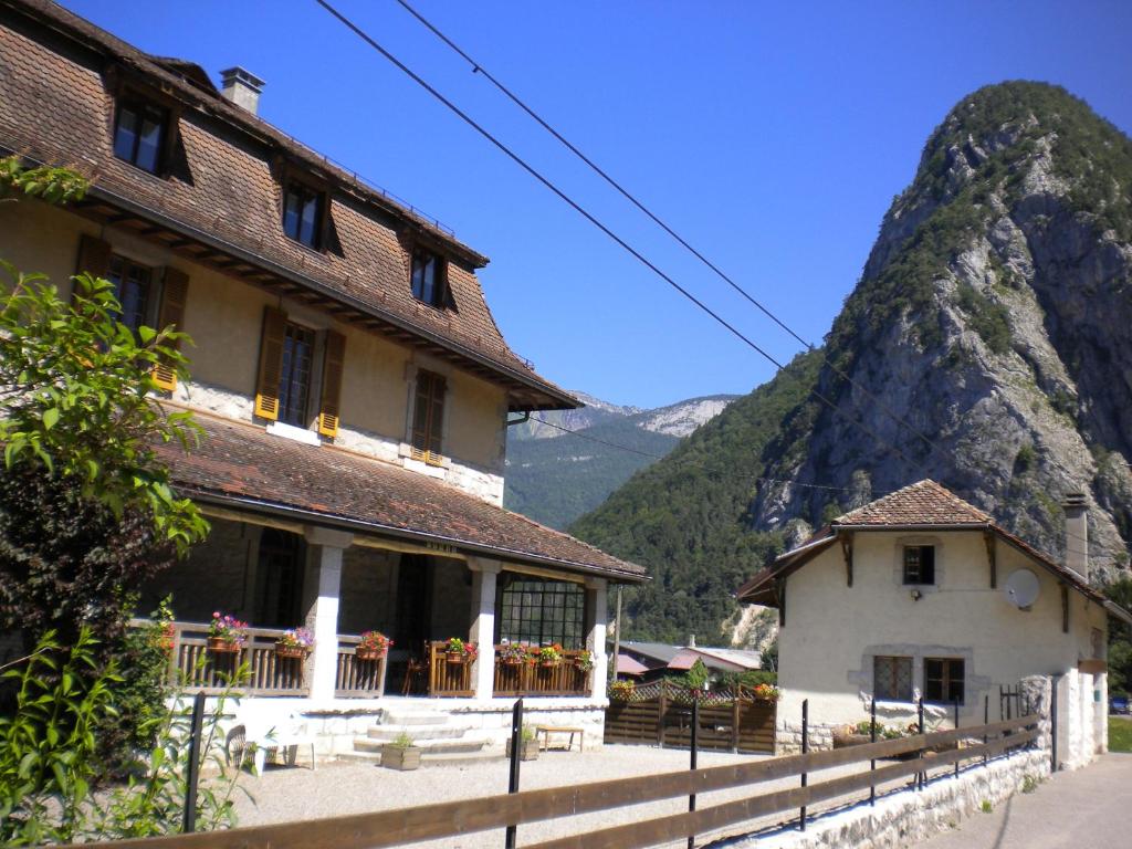 a building with a mountain in the background at Gîte Les Mésanges in Thônes