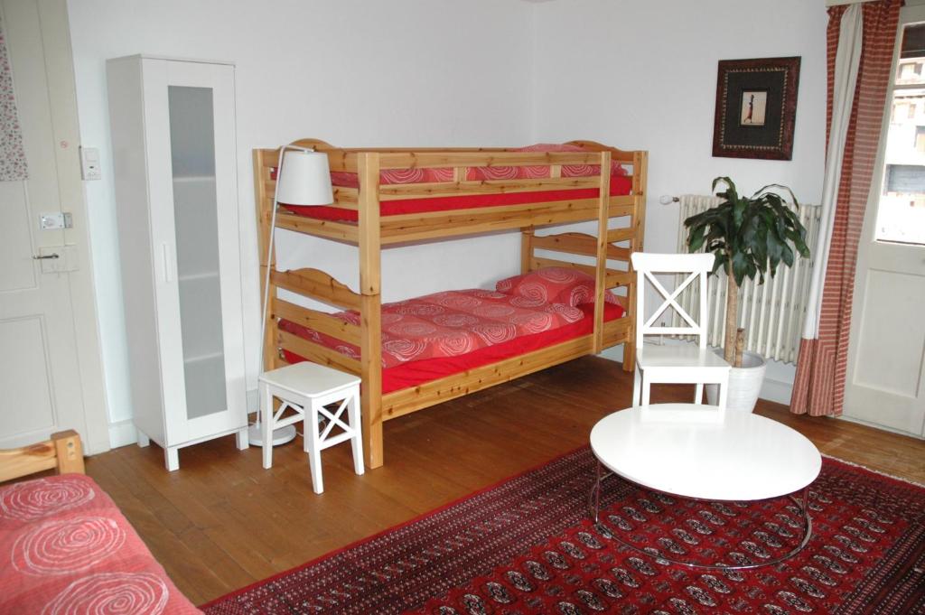 a room with two bunk beds and a rug at Chalet la Griotte in Villars-sur-Ollon