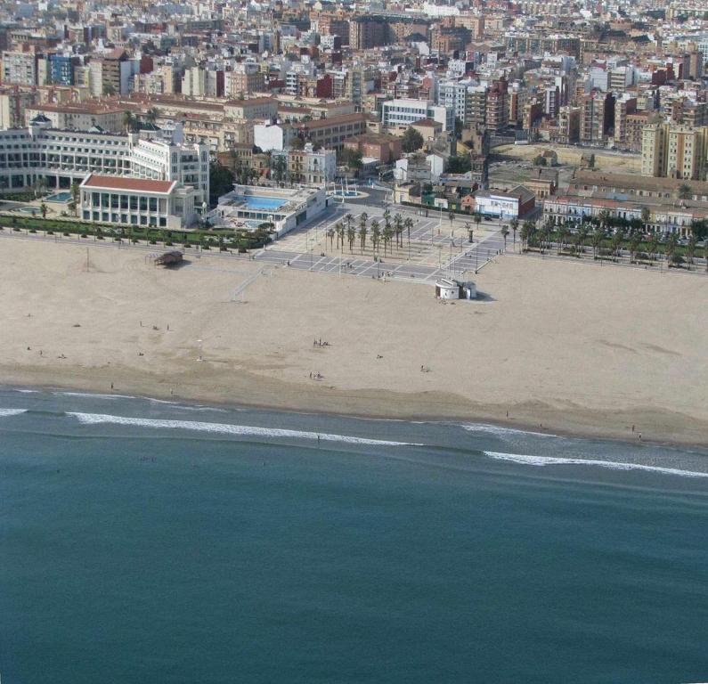 a view of a beach with a city in the background at Malvarrosa Calle Pavia in Valencia