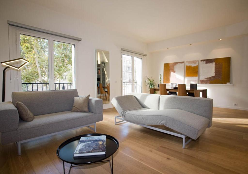 ein Wohnzimmer mit einem Sofa und einem Tisch in der Unterkunft App-Arte Marseille Vieux-Port in Marseille