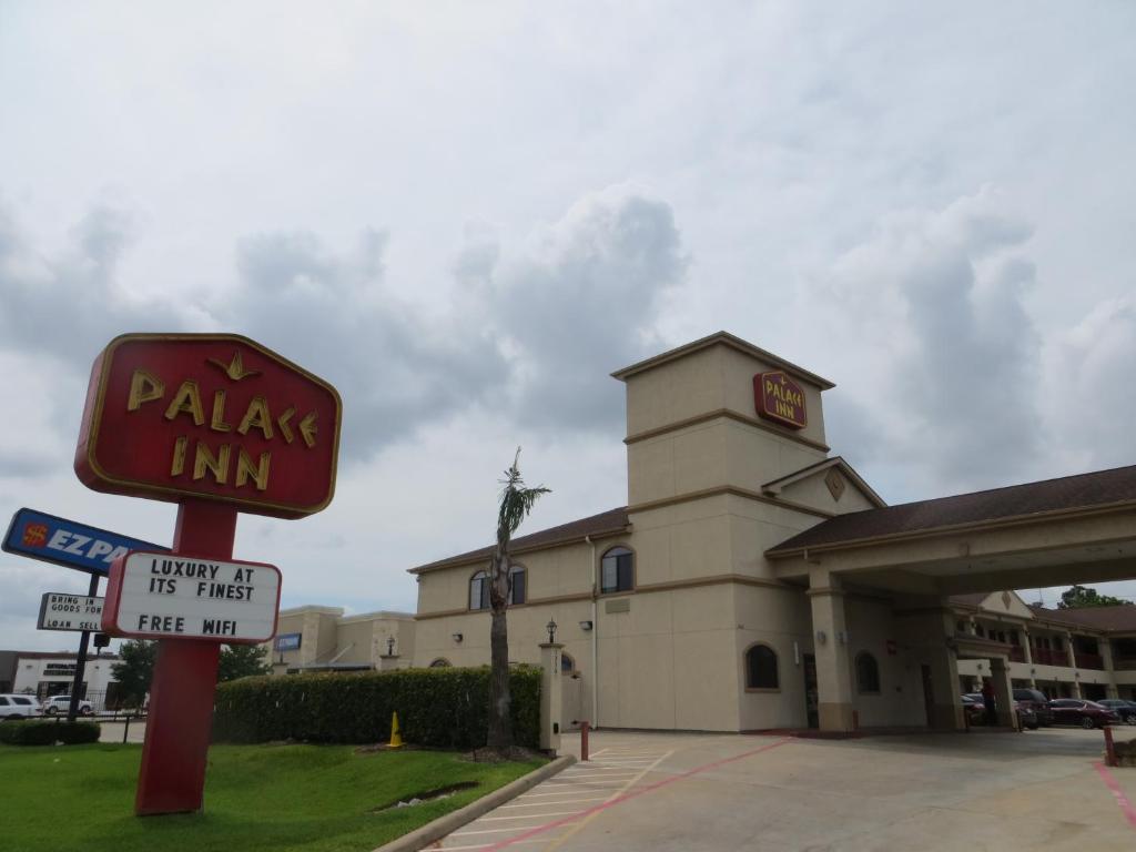 a pizza inn sign in front of a building at Palace Inn Westheimer in Houston