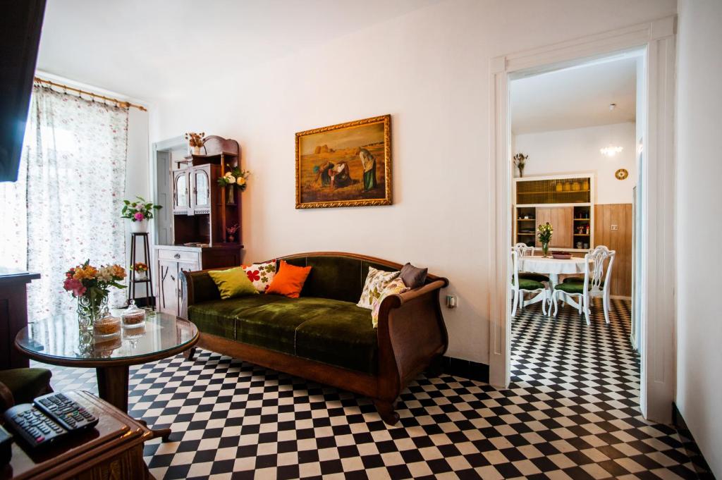 a living room with a green couch and a table at Apartment Liliana in Split