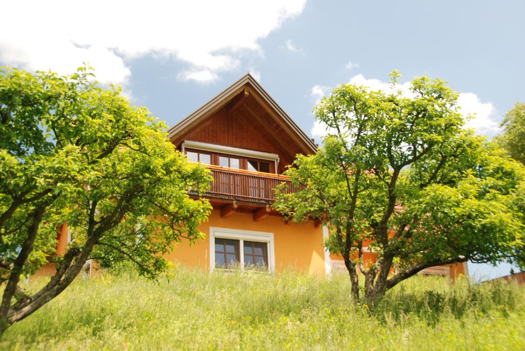 a house on a hill with trees in front of it at Ferienwohnung Sommeregger in Leutschach