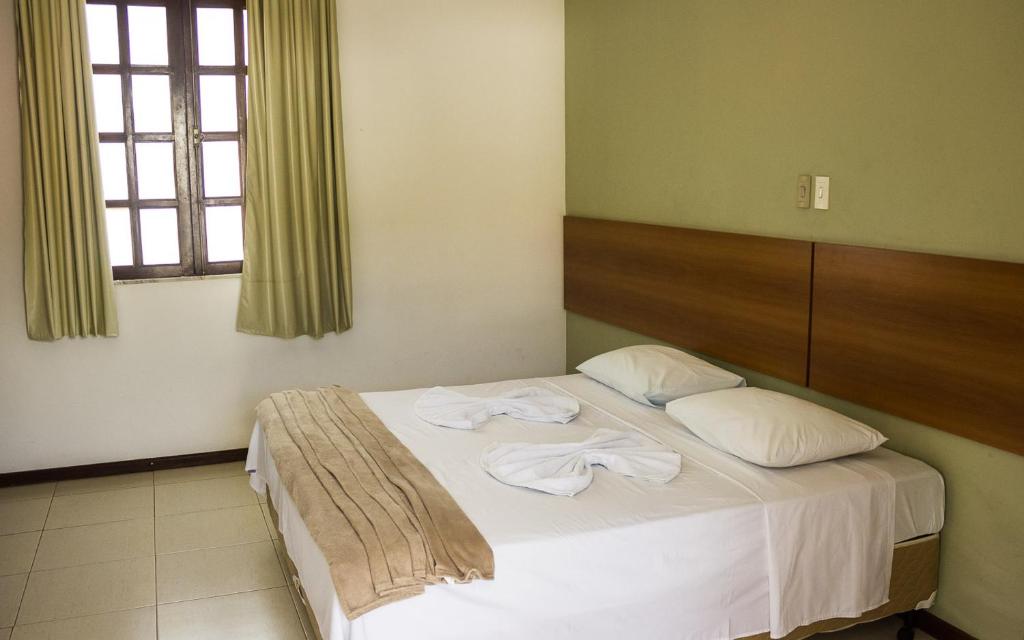 Postel nebo postele na pokoji v ubytování Hotel Pousada Trevo