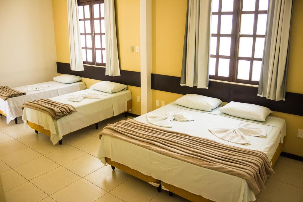 Postel nebo postele na pokoji v ubytování Hotel Pousada Trevo