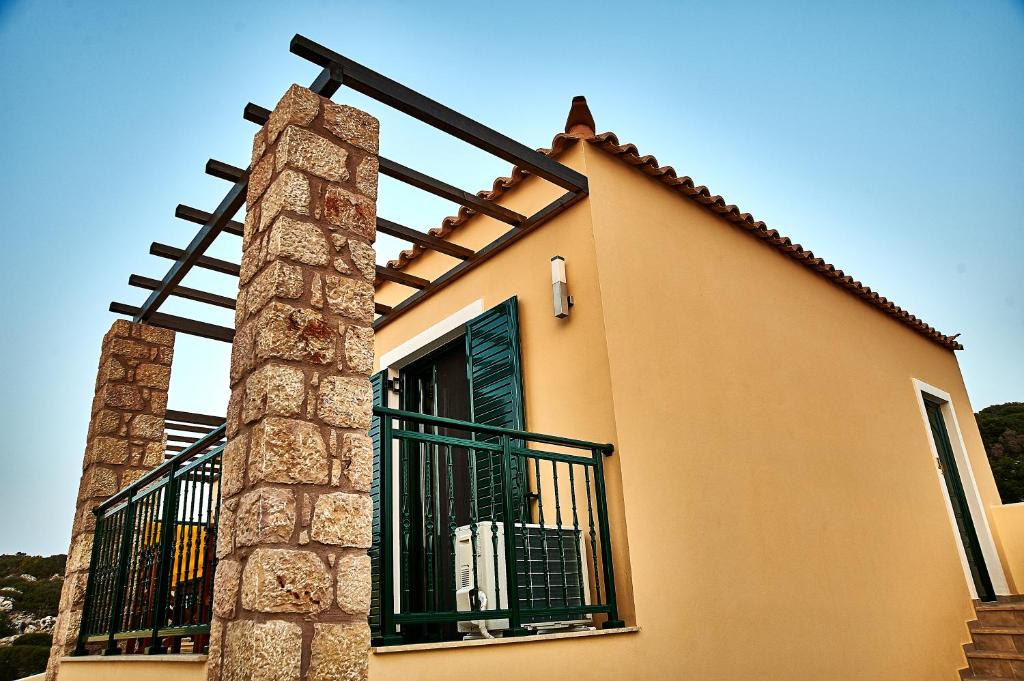 a house with a gate on the side of it at Element Hotel in Elafonisos
