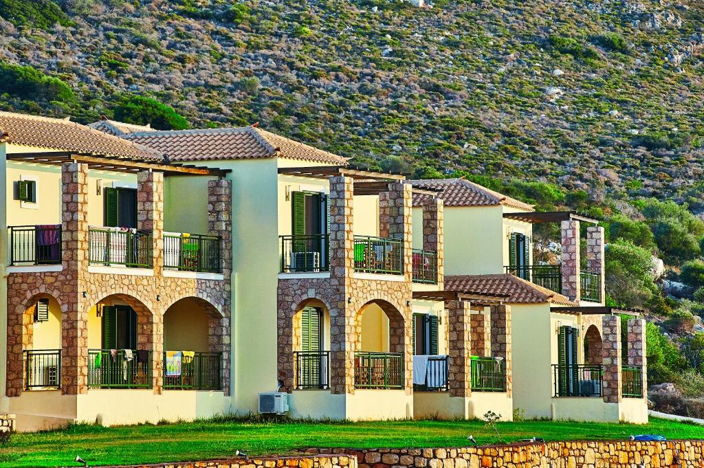 a row of houses in front of a mountain at Element Hotel in Elafonisos