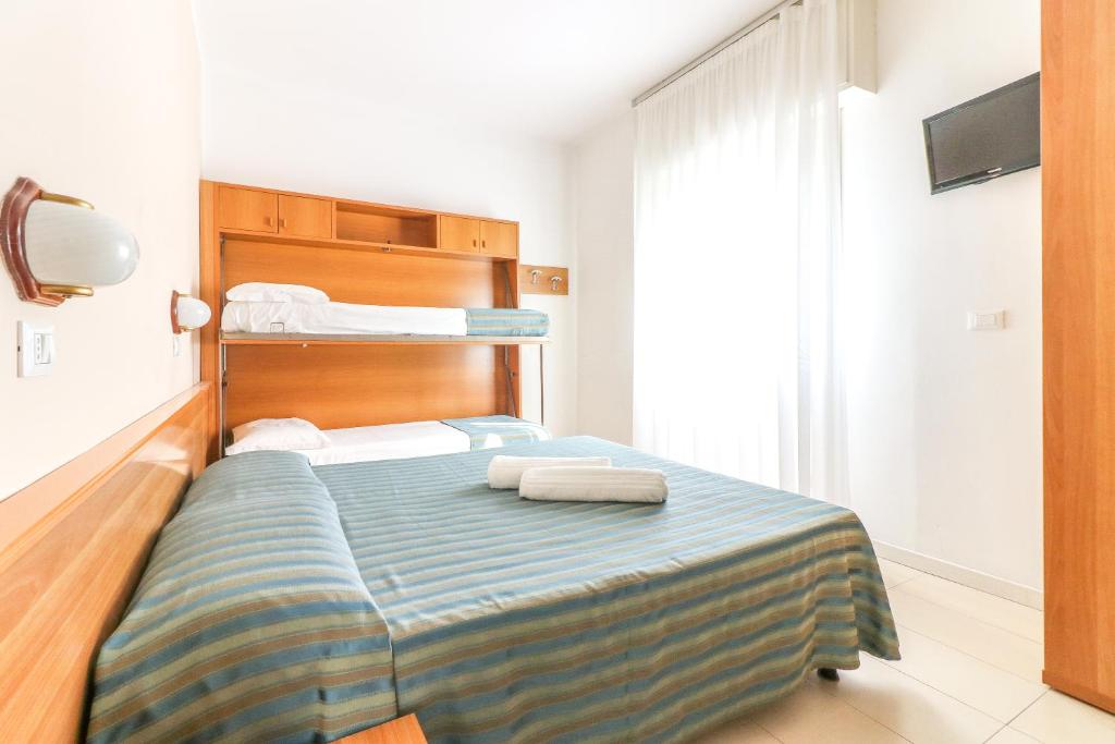 Postel nebo postele na pokoji v ubytování Hotel Jesulum