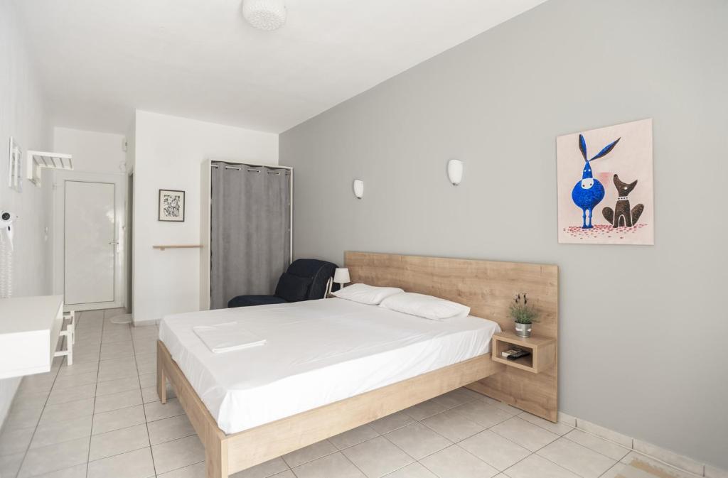 a bedroom with a bed and a desk and a chair at Afkos Apartments in Polykhrono