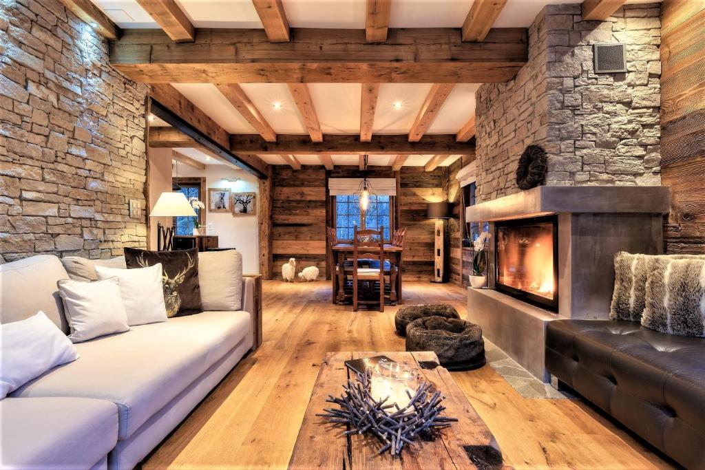 a living room with a couch and a fireplace at Chalet le Petou in Champéry