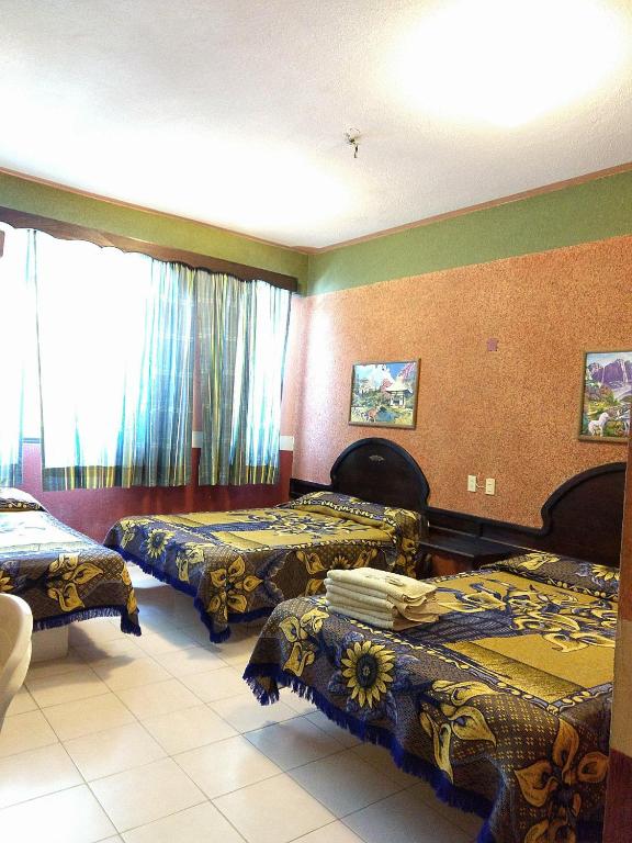 Postel nebo postele na pokoji v ubytování Hotel Real del Quijote a sólo 50 metros de la playa