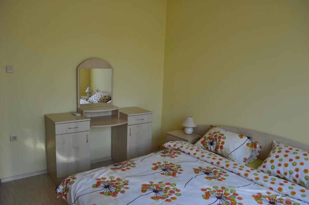 a bedroom with a bed with a vanity and a mirror at Одеса 37 in Sozopol