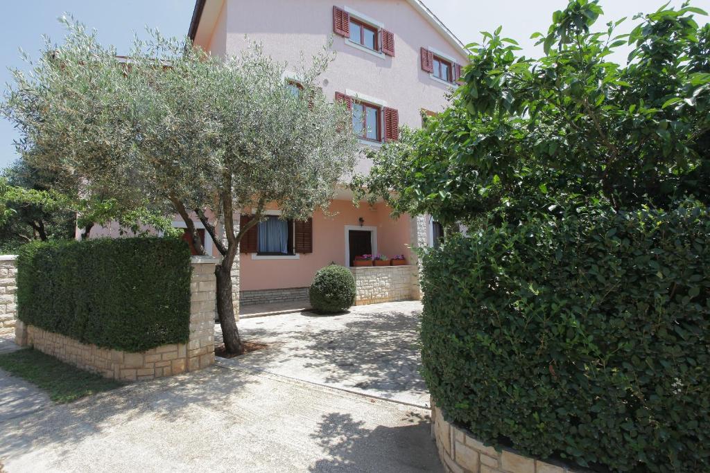 a large house with trees in front of it at Guest House Ljubica in Medulin