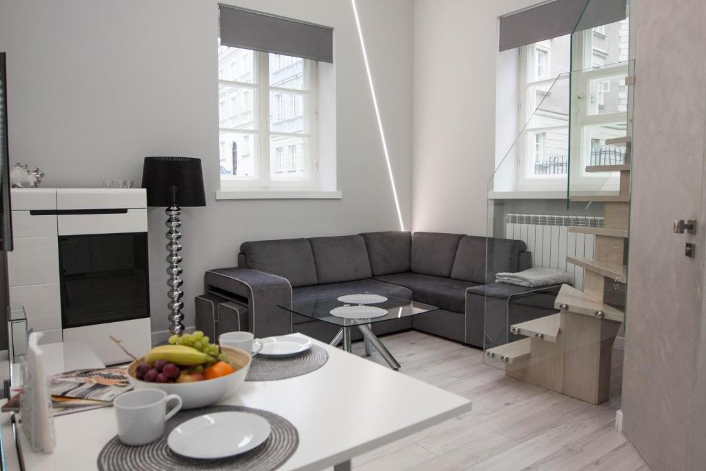 a living room with a couch and a table at Apartament MnW in Warsaw