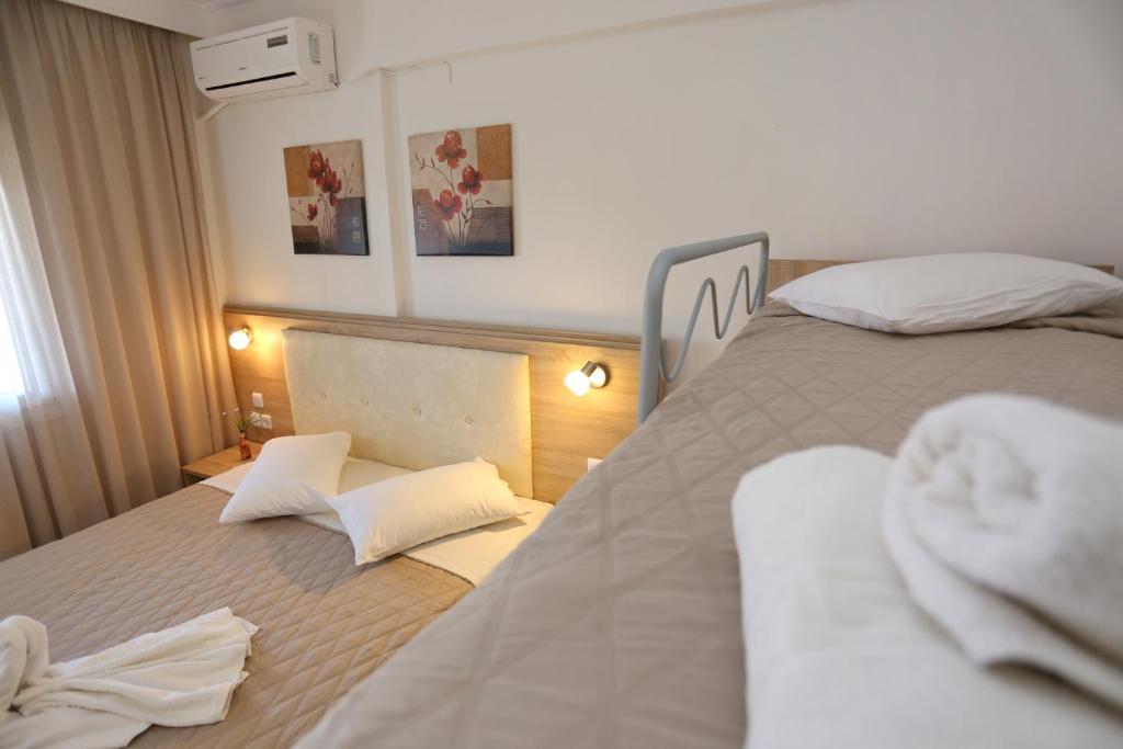 Posteľ alebo postele v izbe v ubytovaní Sun Hotel