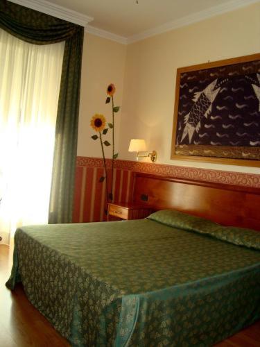 Postel nebo postele na pokoji v ubytování Hotel Verdi