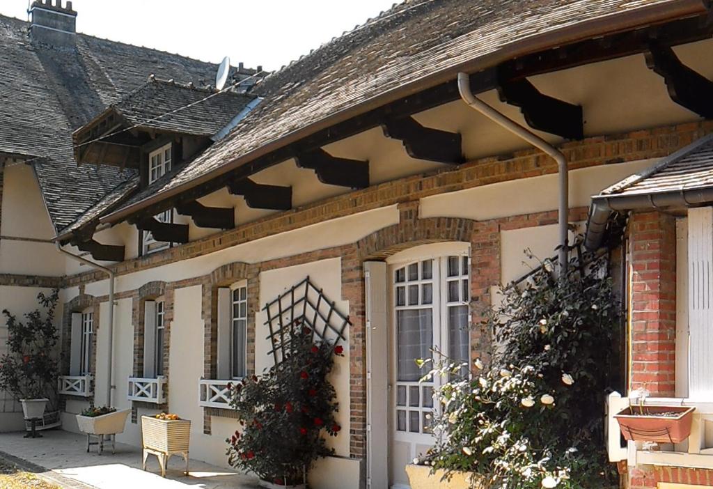 a house with christmas wreaths on the side of it at Maison Lalongère in Longueville