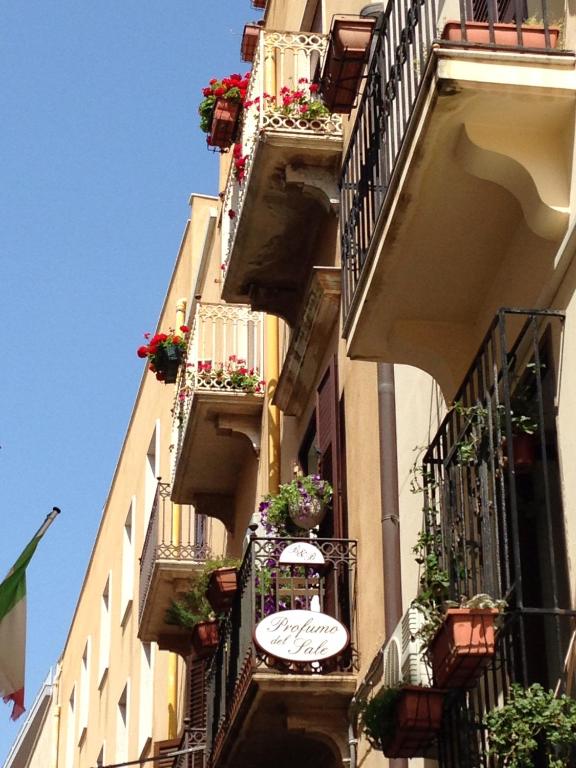 a building with balconies and a sign on the side of it at Il Profumo del Sale in Marsala