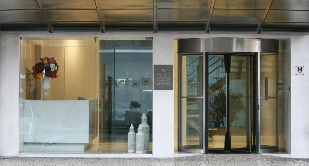 a store front with glass doors in a building at Hotel Costa Verde in Póvoa de Varzim