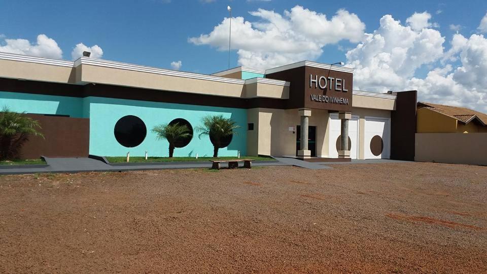 a hotel with a mural on the side of a building at Hotel Vale Do Ivinhema in Bataiporã