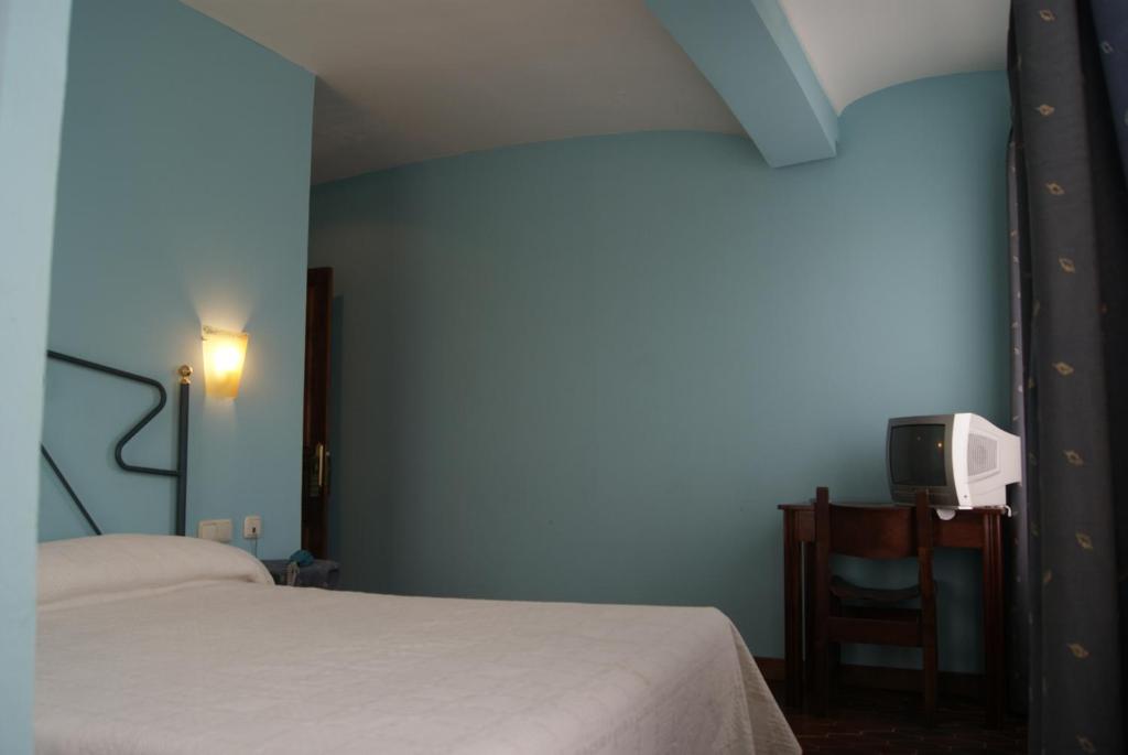 Postel nebo postele na pokoji v ubytování Hotel Los Laureles