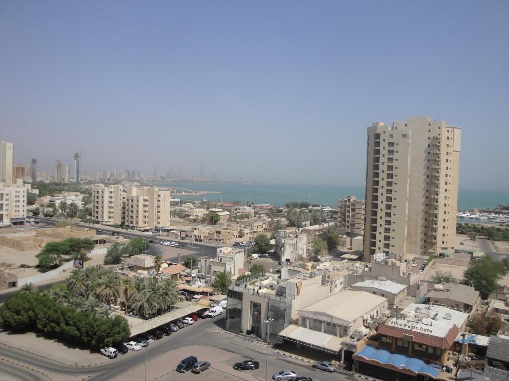 an aerial view of a city with tall buildings at Marina Royal Hotel Suites in Kuwait