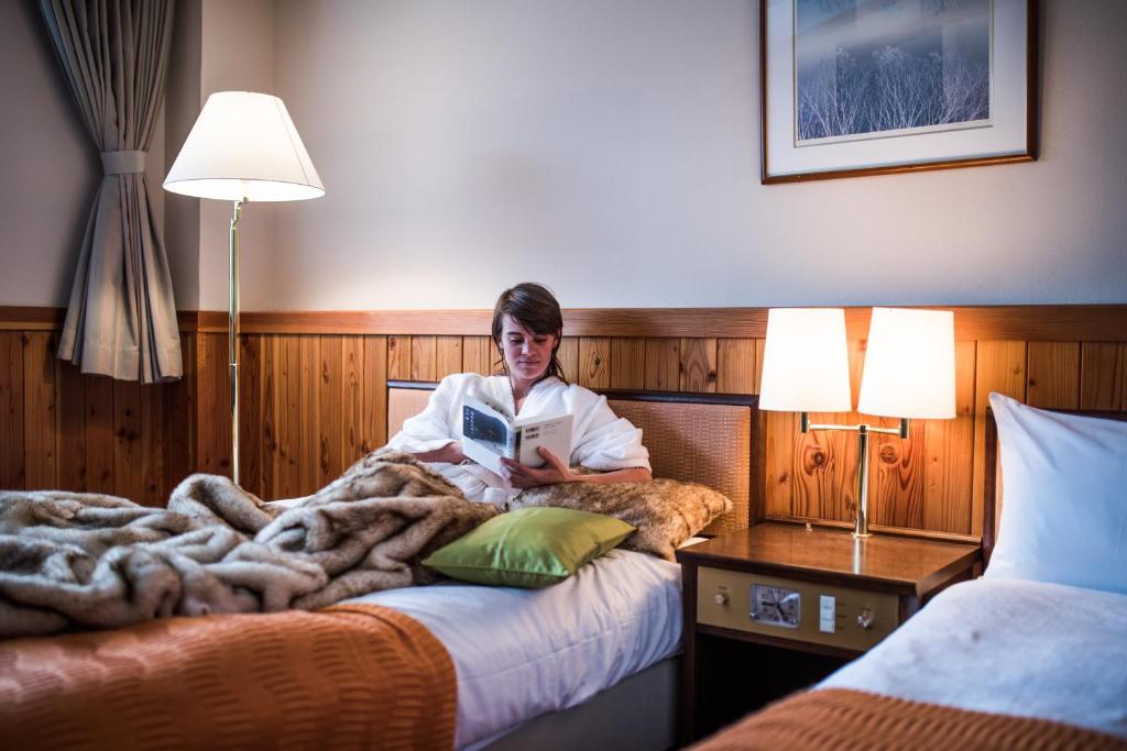 Postel nebo postele na pokoji v ubytování Okushiga Kogen Hotel