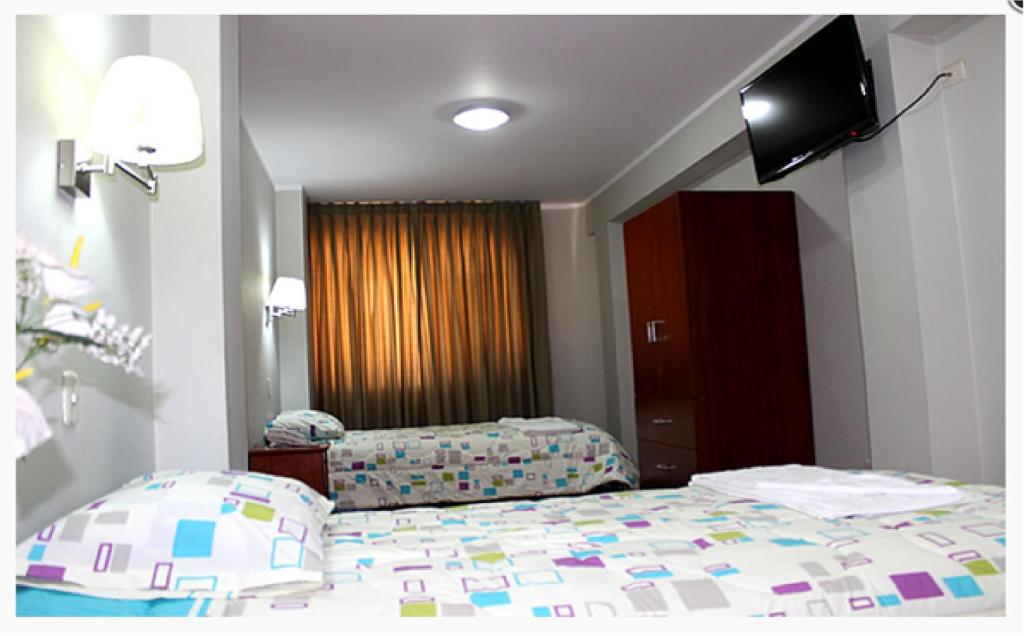Postel nebo postele na pokoji v ubytování Hostal Residencial Lino