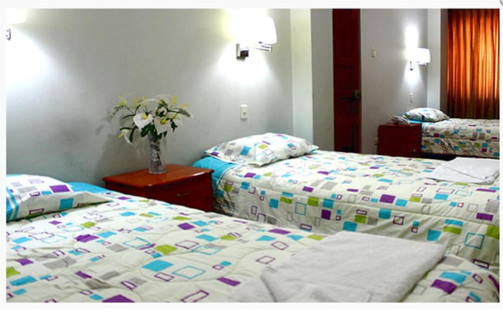 Postel nebo postele na pokoji v ubytování Hostal Residencial Lino