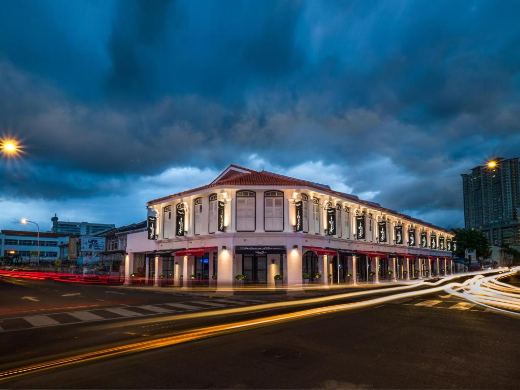 a building on a city street at night at Macallum Central Hotel Managed by The Ascott Limited in George Town