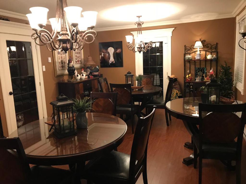 a dining room with tables and chairs and a chandelier at Castle Landing in Placentia
