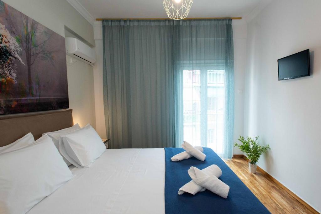 Łóżko lub łóżka w pokoju w obiekcie Blue Ark Stylish Athens