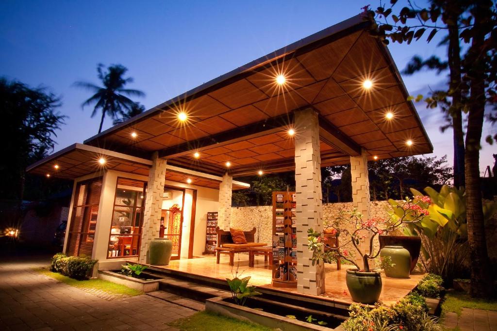 a small house with a roof with lights on it at Ellora Villa in Sanur