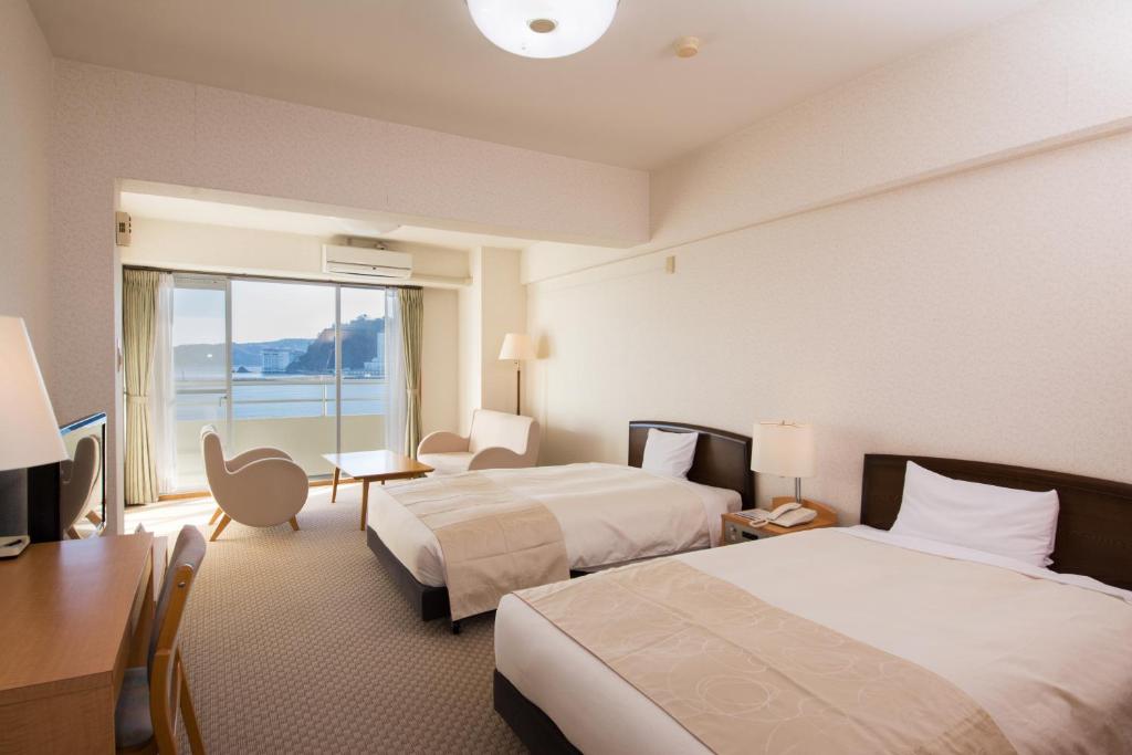 Postel nebo postele na pokoji v ubytování Wisterian Life Club Atami