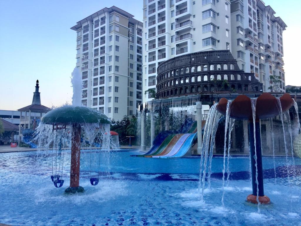 een fontein in het midden van een stad met gebouwen bij Amari Lagoon Park Resort in Melaka