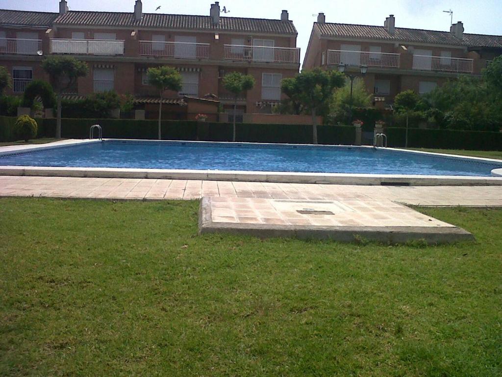 a large swimming pool in front of a building at casudha de juanda in Grao de Castellón