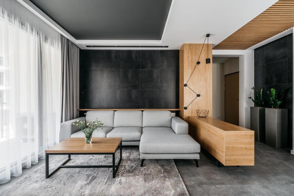 a living room with a couch and a table at Vistula Apartments by LoftAffair in Krakow