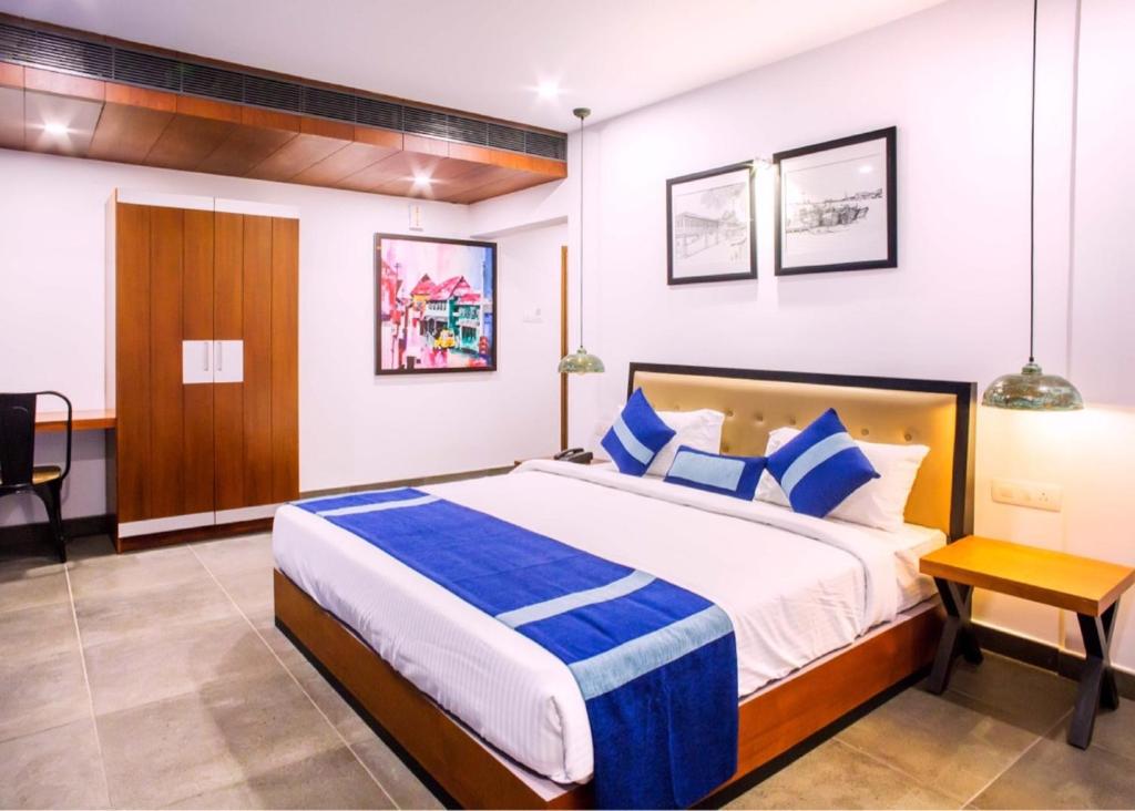 Postel nebo postele na pokoji v ubytování Hotel Neighbourhood, Cochin
