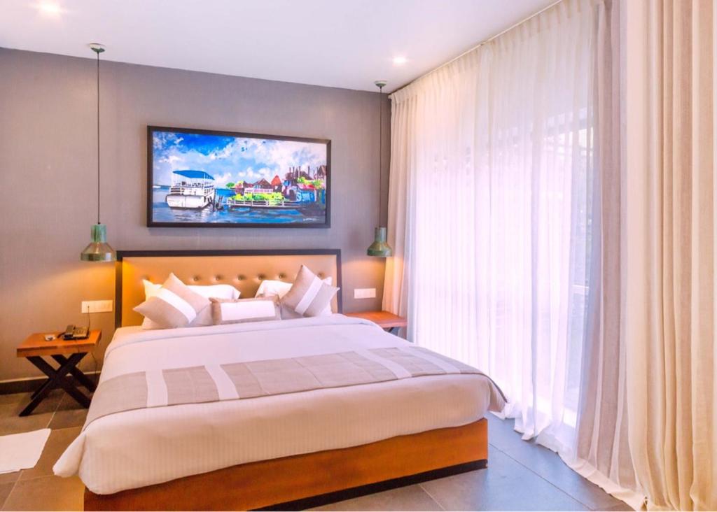 Postel nebo postele na pokoji v ubytování Hotel Neighbourhood, Cochin