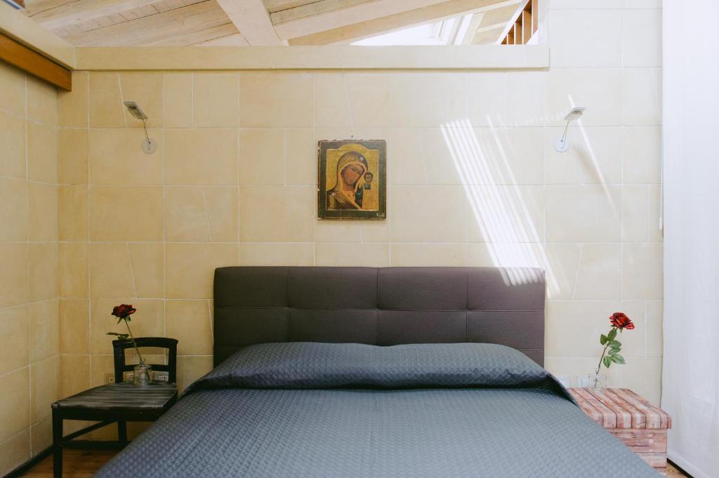 Un dormitorio con una cama y un cuadro en la pared. en Attico dell'Artista, en Desenzano del Garda