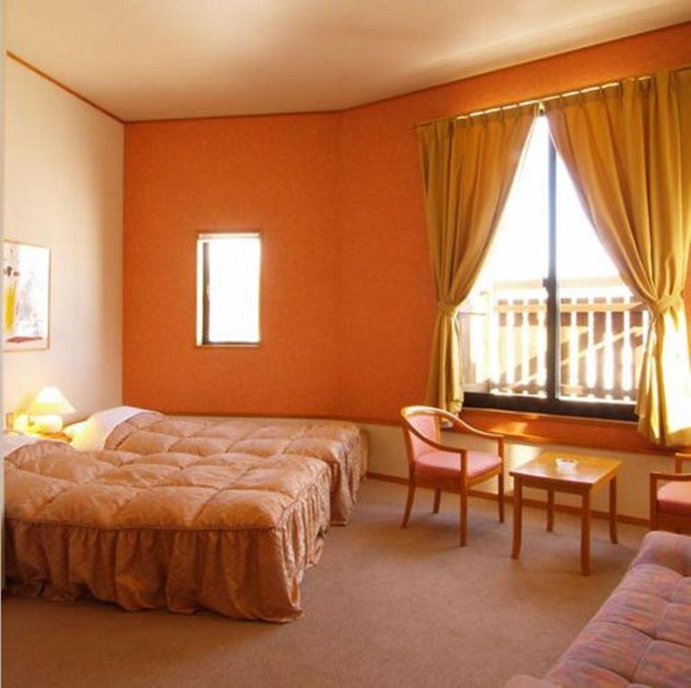 Postel nebo postele na pokoji v ubytování Hakuba Alpine Hotel