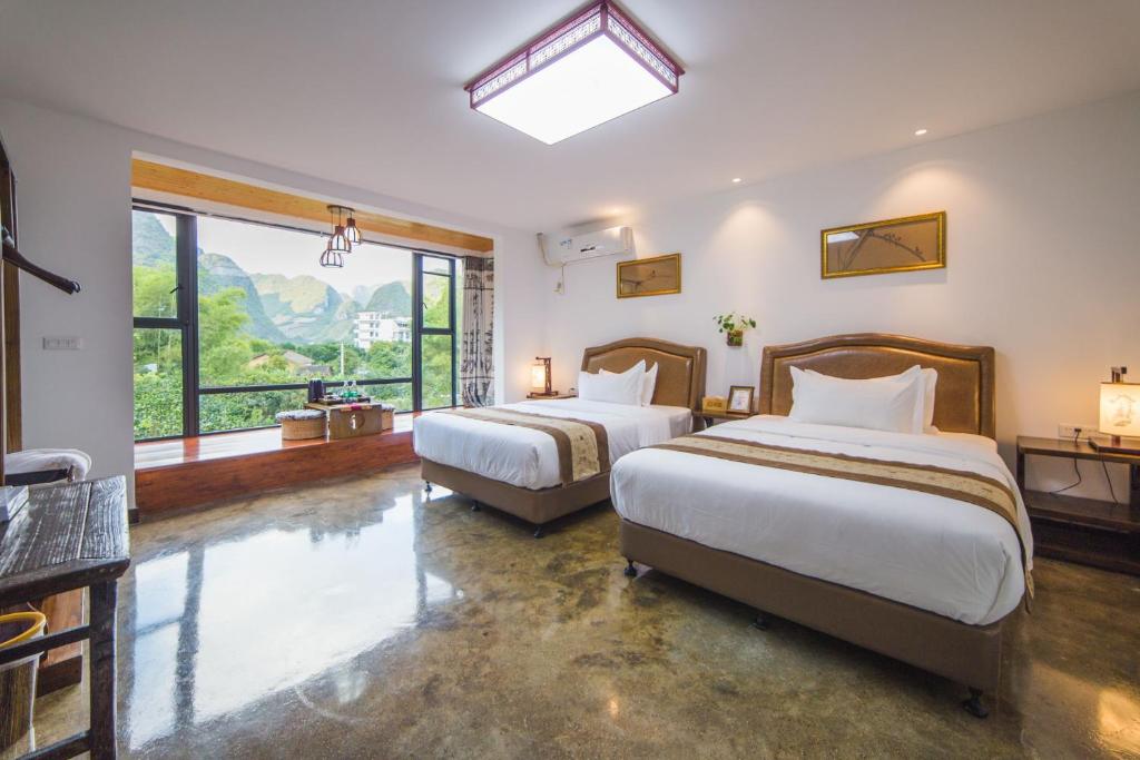 Postel nebo postele na pokoji v ubytování Leisure Courtyard Hotel Yangshuo-Free shuttle bus to Yangshuo station stay 2 nights One Way