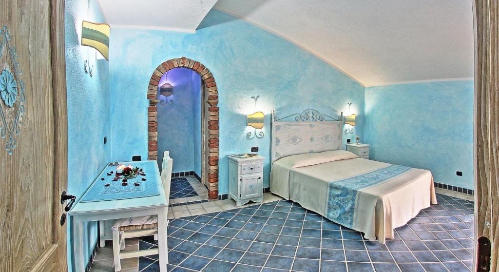 ein Schlafzimmer mit einem Bett und einem Tisch darin in der Unterkunft Sa Reposada in Càbras