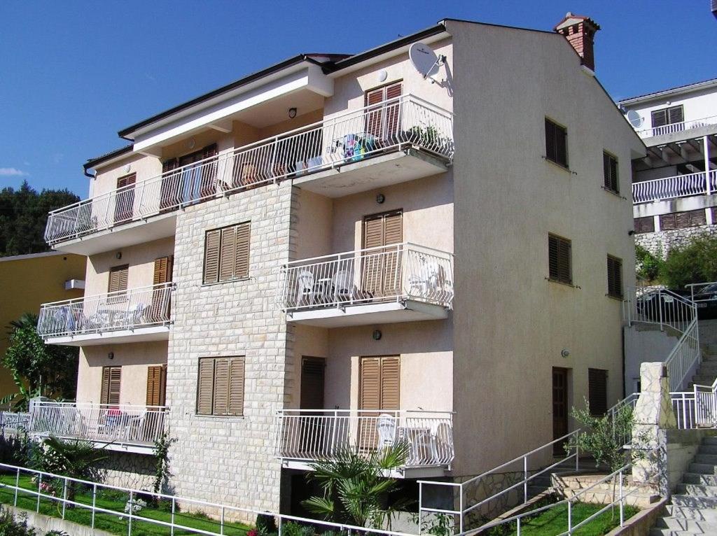 a large building with balconies on the side of it at Apartments Villa Adria in Rabac