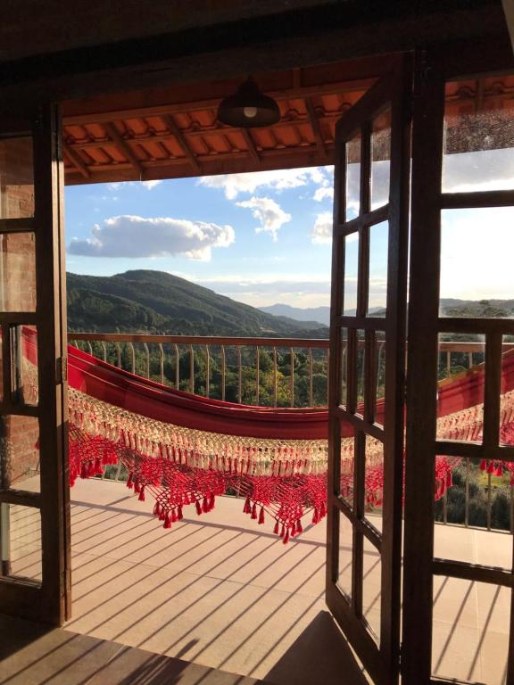 a view from an open window of a balcony at Pousada Pinho Bravo in Camanducaia