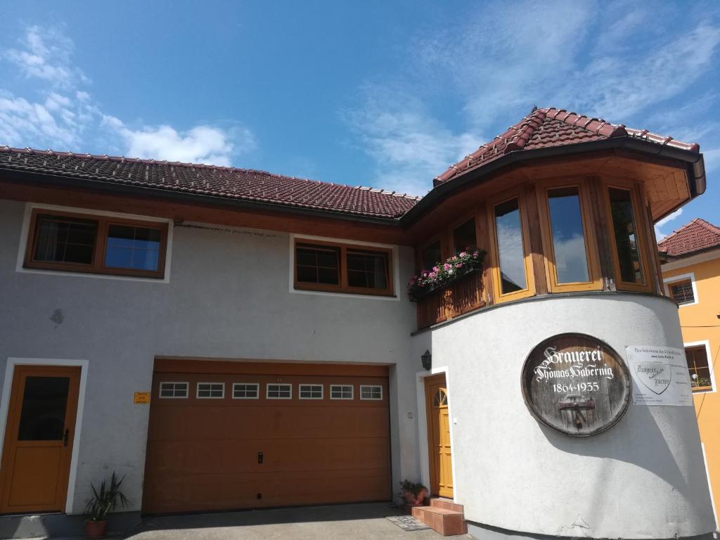 a house with a sign on the front of it at Ferienwohnung Schmetterling in Liebenfels