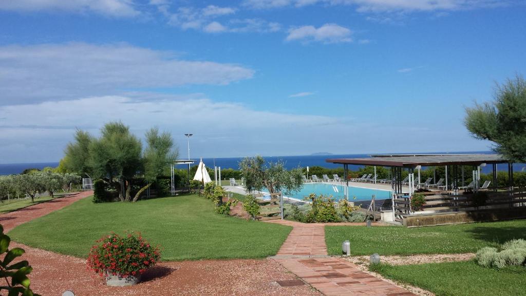 a resort with a swimming pool and a garden at Casale del Mare in Castiglioncello