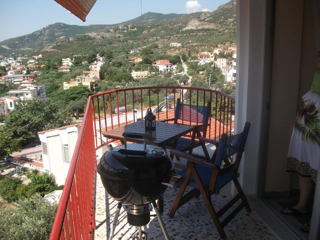 a balcony with a table and chairs and a view at Konstantina’s House in Paleo Tsifliki