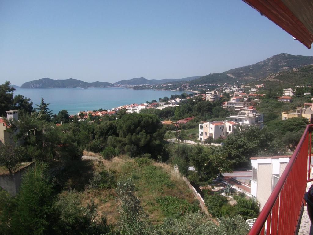 a view from a balcony of a town and a lake at Konstantina’s House in Paleo Tsifliki